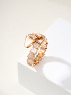 Rose gold-tone hinged bracelet with angular geometric squares and crystal accents