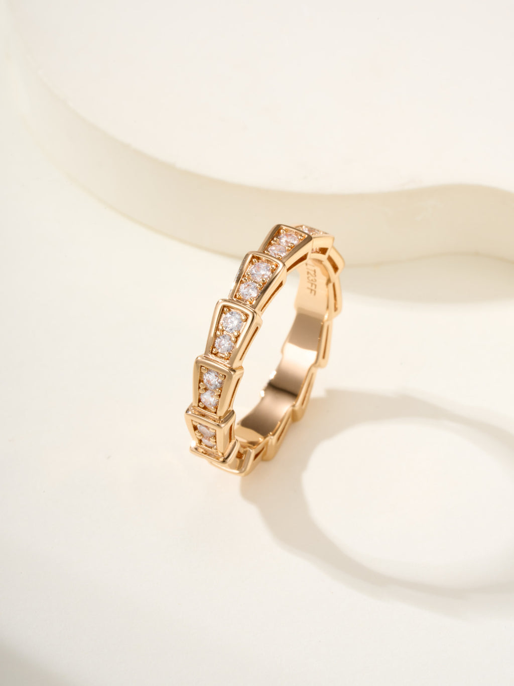 Gold gemstone bangle with rectangular settings and square-cut stones.