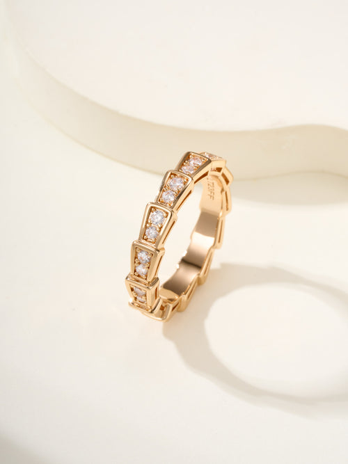 Gold gemstone bangle with rectangular settings and square-cut stones.