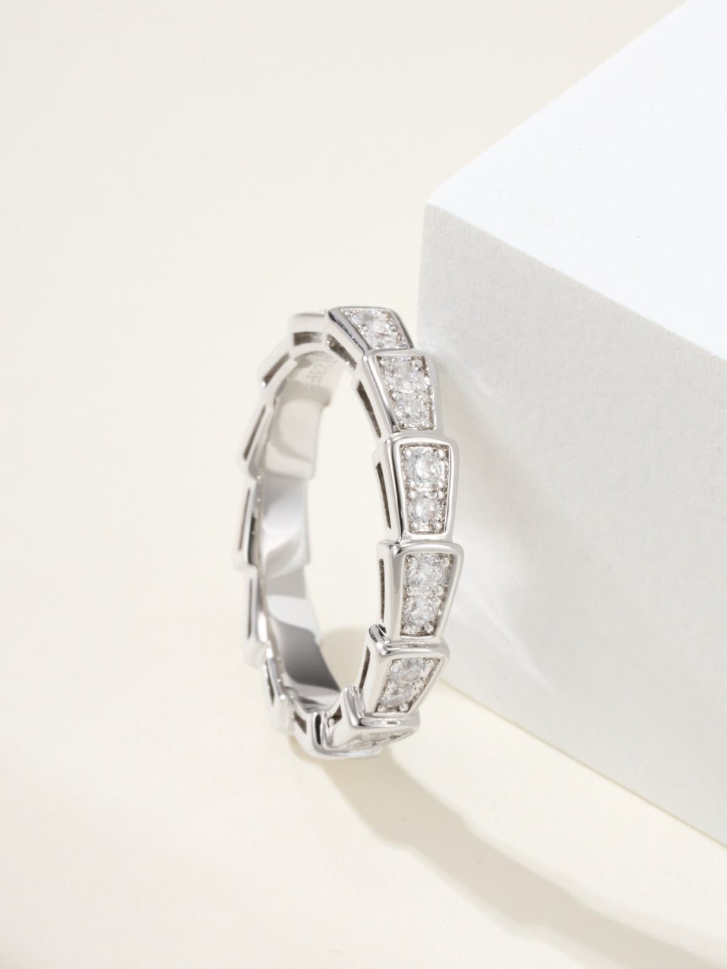 Silver gemstone bangle with bezel-set stones and a slim circular profile.
