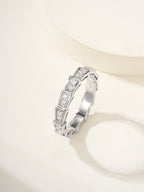 Silver gemstone bangle with rectangular settings and square-cut stones.