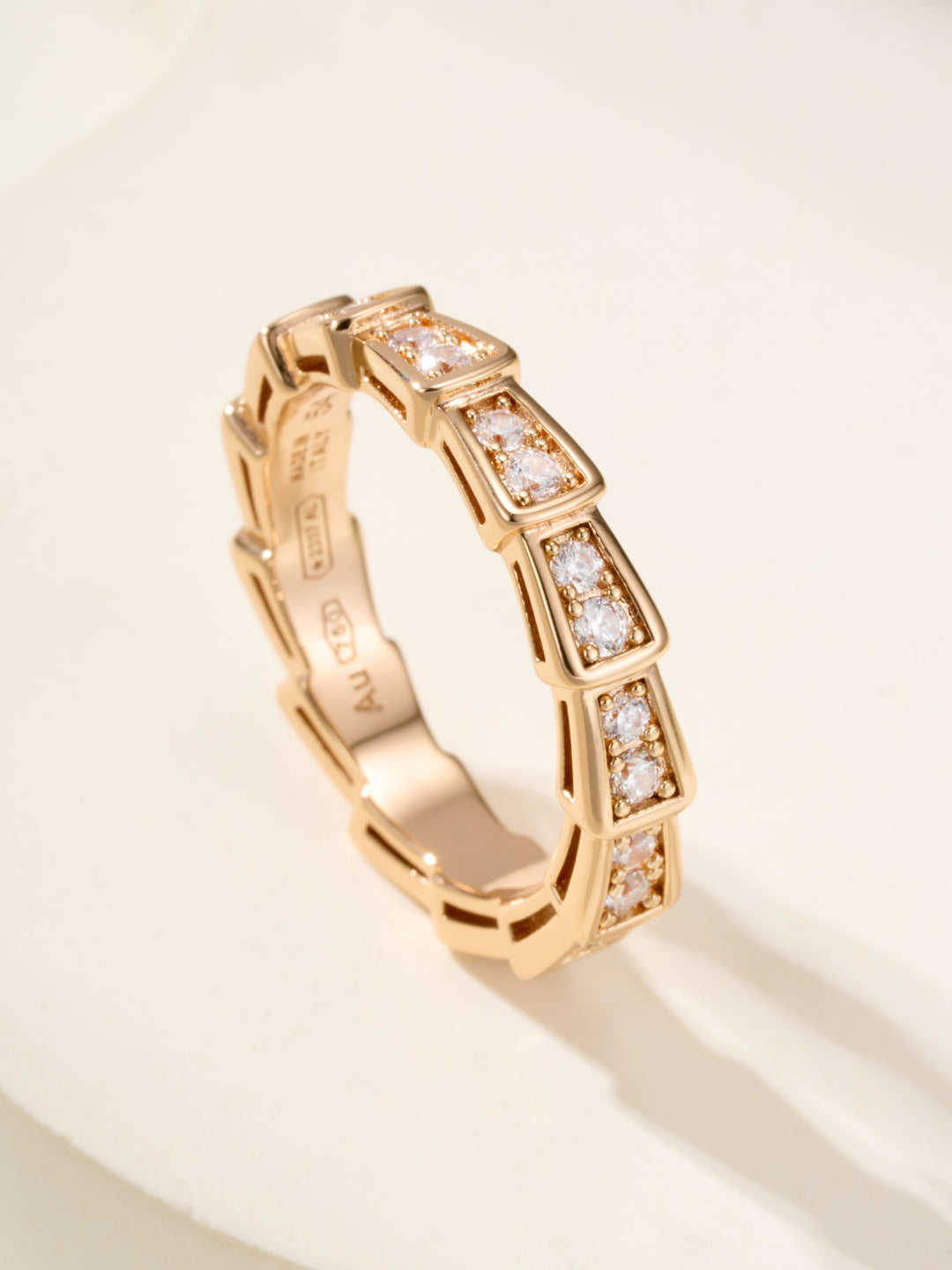 Gold gemstone bangle with rectangular bezel-set stones, close-up angle.