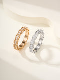 Gold and silver gemstone bangle set with square-cut stones, hinged-style.