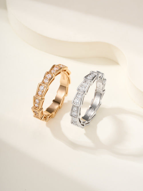 Gold and silver gemstone bangle set with square-cut stones, hinged-style.