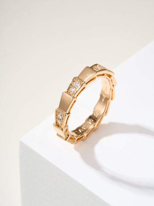 Bvlgari gold bangle bracelet with rectangular link design and small clear gems