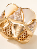 Bvlgari gold-tone ring close-up with engraved interior and openwork patterned band.