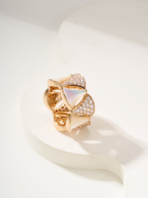 Bvlgari gold-tone ring with white teardrop insets and pavé crystal details, openwork band.