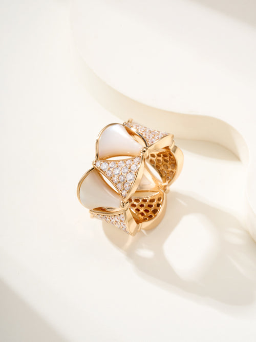 Bvlgari gold-tone ring with white teardrop insets and pavé stones on an openwork design.