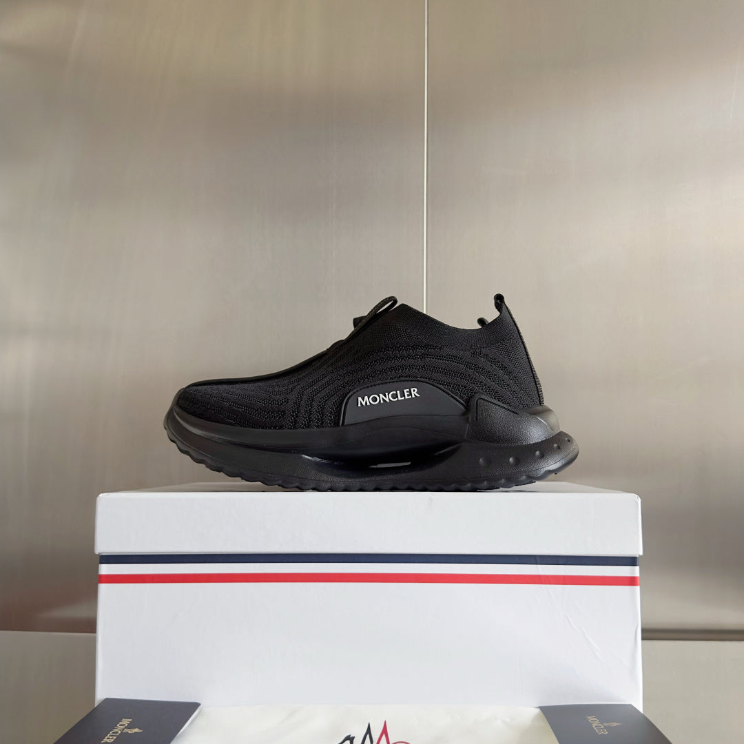 Moncler low-top slip-on sneaker with dark knit upper and sculpted rubber sole