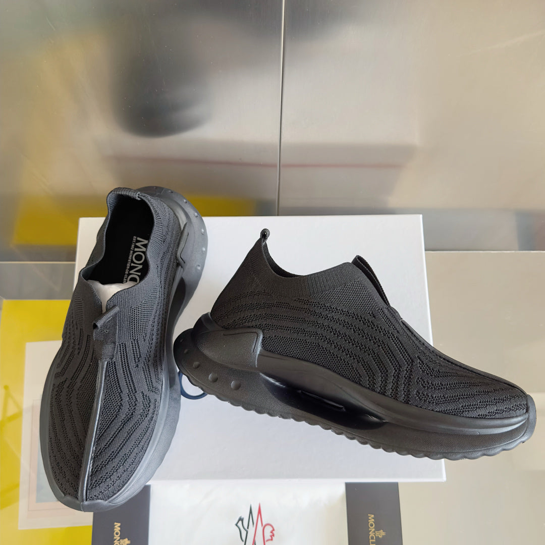 Moncler knit slip-on sneakers, side view showing chunky tread and logo patch