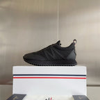 Moncler slip-on style running sneakers in dark gray with ribbed side texture and tread.