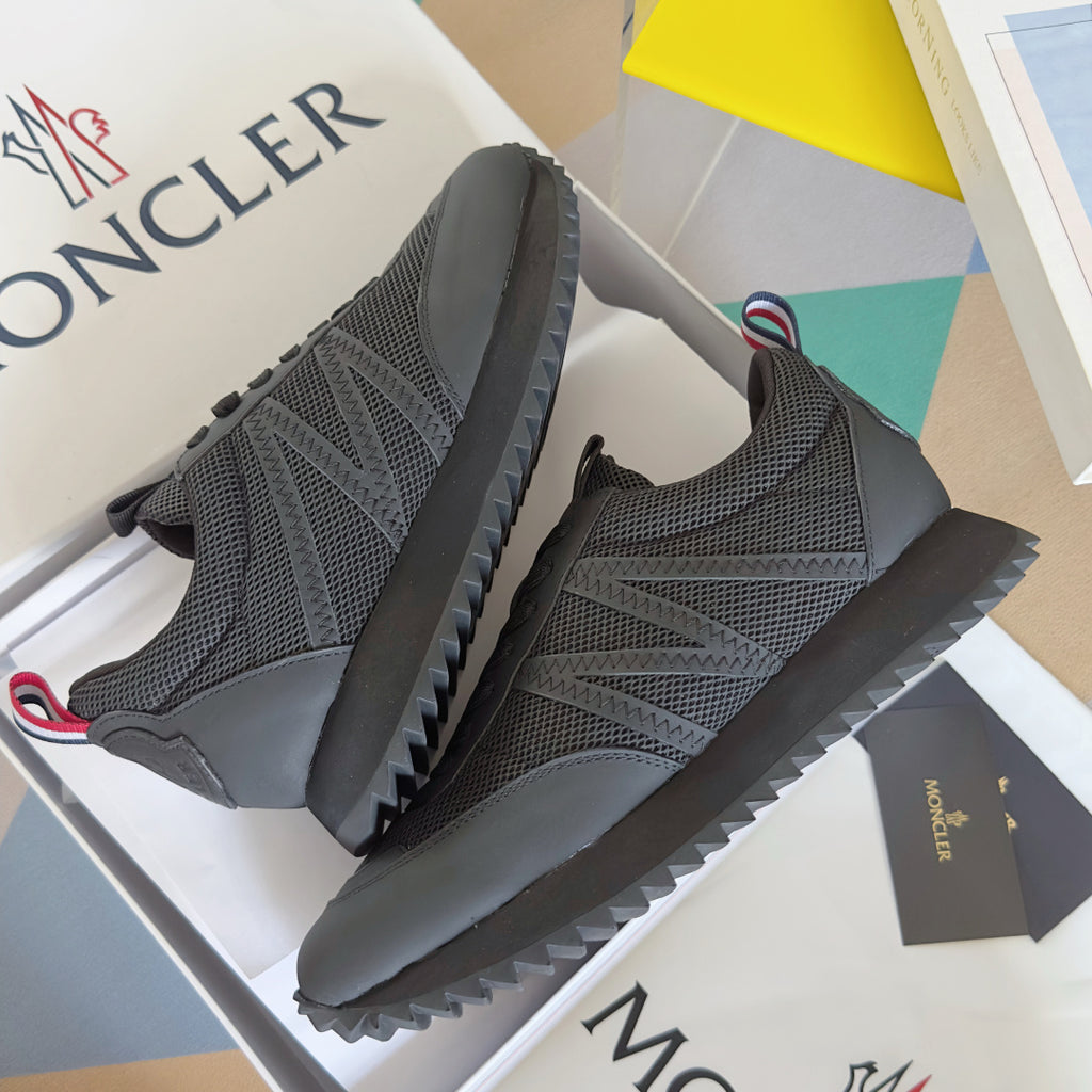 Moncler low-top sneakers in dark gray with mesh upper, lace-up front, and grip sole.
