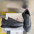 Moncler lace-up sneakers, dark gray, with side stripes and rugged tread outsole.