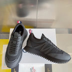 Moncler low-top sneakers in dark gray with lace-up closure and chunky zigzag sole.