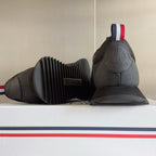 Moncler sneakers, dark gray, shown from heel with ribbed sole and back logo detail.