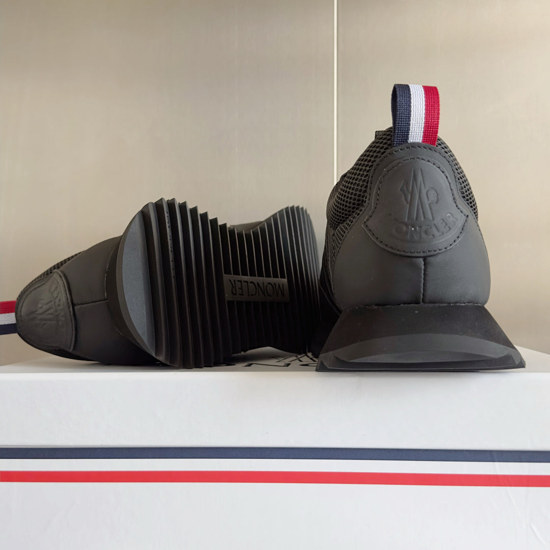 Moncler sneakers, dark gray, shown from heel with ribbed sole and back logo detail.