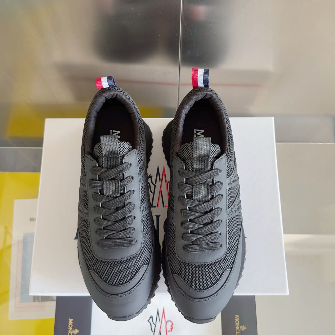 Moncler lace-up sneakers, dark gray, with logo tongue patch and textured front panels.
