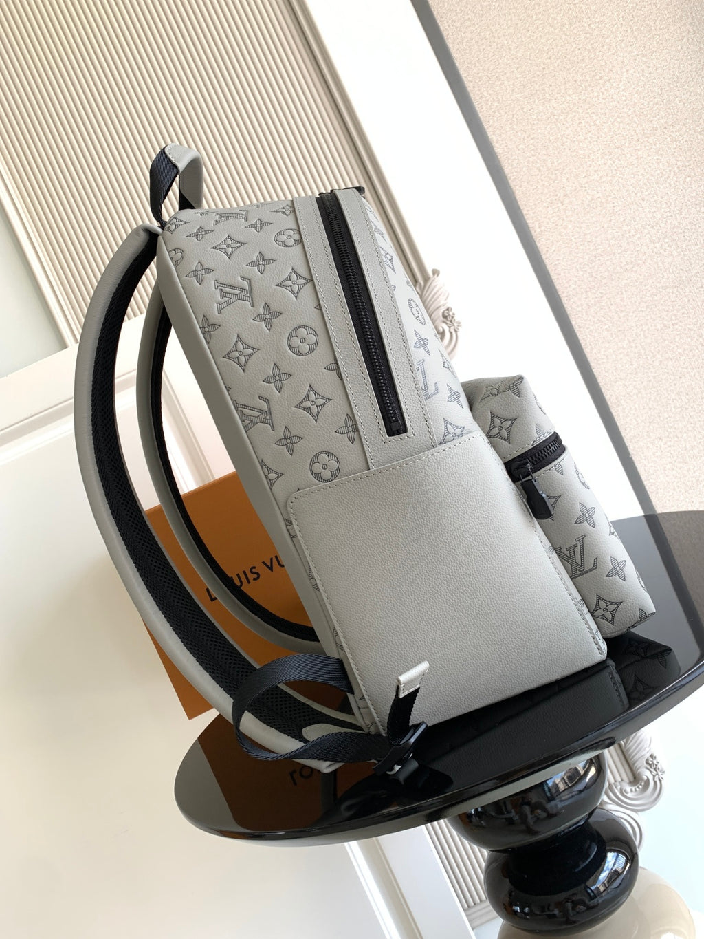 Louis Vuitton monogram tote bag with black zip, white leather trim, and side straps