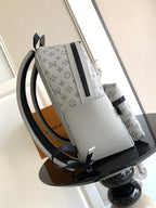 Louis Vuitton monogram tote bag with black zip, white leather trim, and side straps