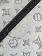 Louis Vuitton monogram leather bag with black zipper and light embossed pattern