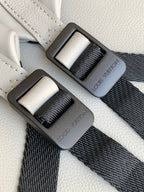 Louis Vuitton monogram bag with black webbing straps and gray buckle details