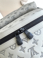 Louis Vuitton monogram leather bag with white trim stitching and black zipper tabs
