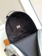 Louis Vuitton monogram backpack with open top, black lining, and inner pocket