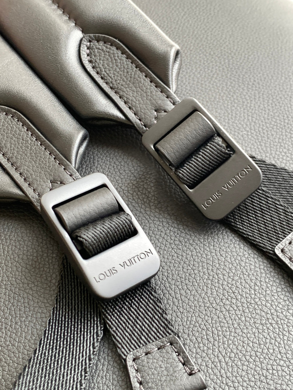 Louis Vuitton monogram backpack close-up of adjustable strap buckles and tabs