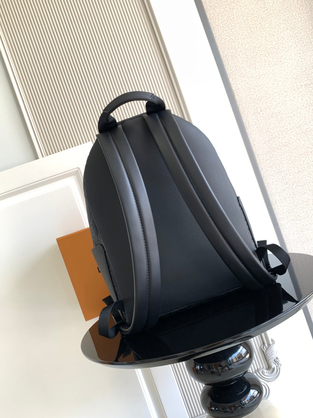 Louis Vuitton monogram mini backpack back view in dark gray/black with padded shoulder straps