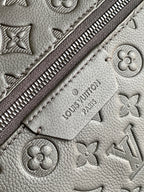 Louis Vuitton monogram backpack close-up of zipper track and embossed logo details