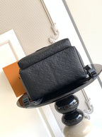 Louis Vuitton monogram backpack angled view with top handle and front flap