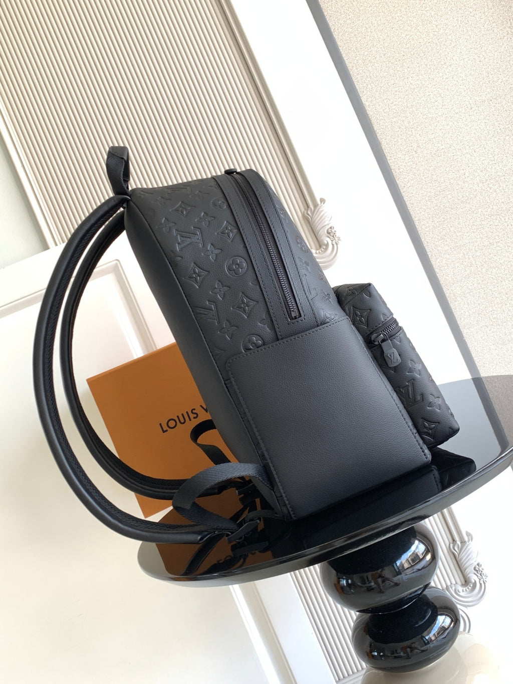 Louis Vuitton monogram backpack with front flap and curved shoulder strap, side view