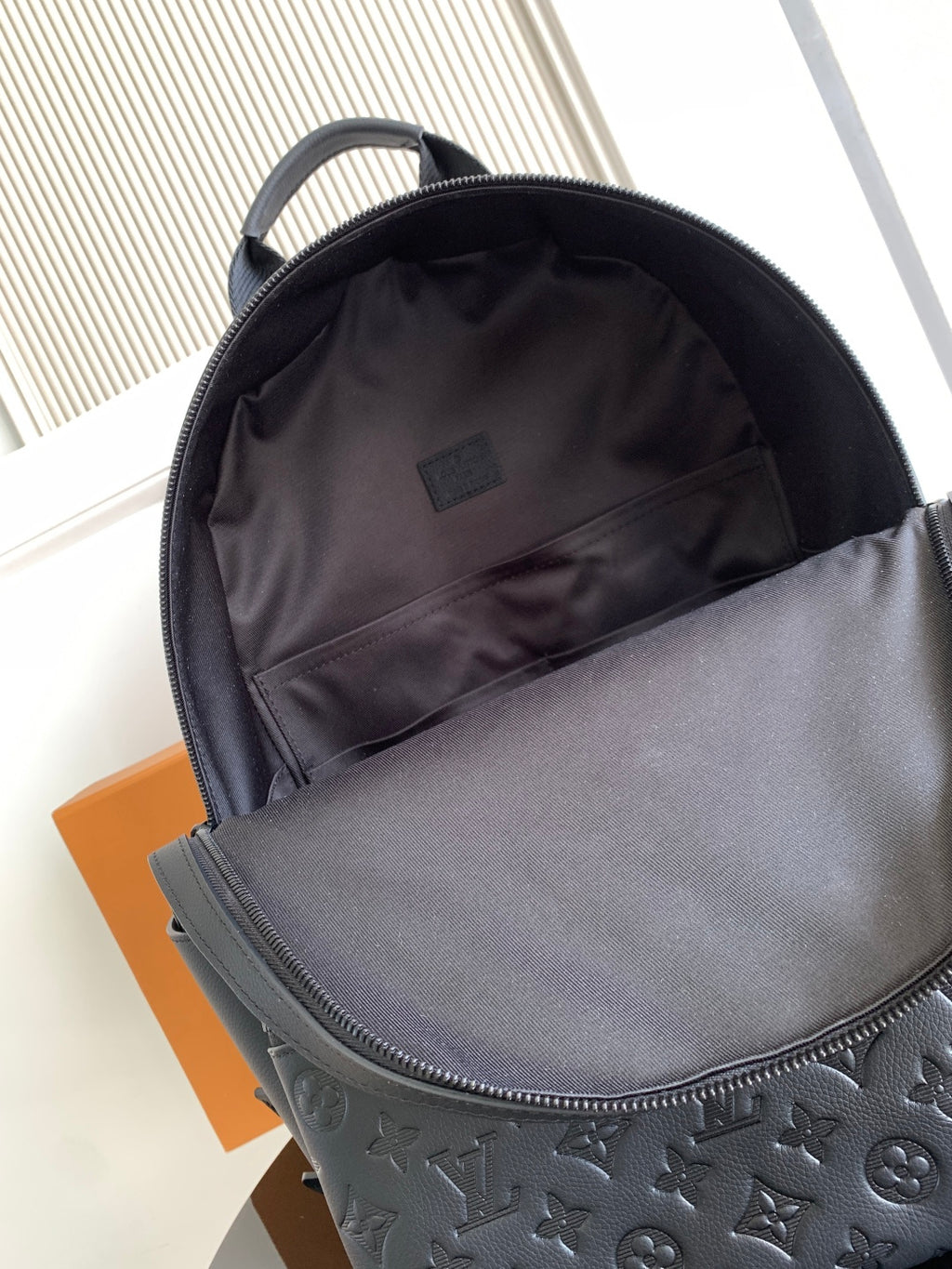 Louis Vuitton monogram backpack interior opening with fabric lining and top zipper