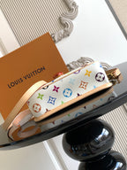 Multicolor monogram crossbody bag with curved flap opening, beige strap, gold trim.