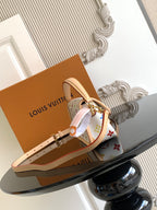 Multicolor monogram crossbody bag with wide beige strap and gold-tone hardware.