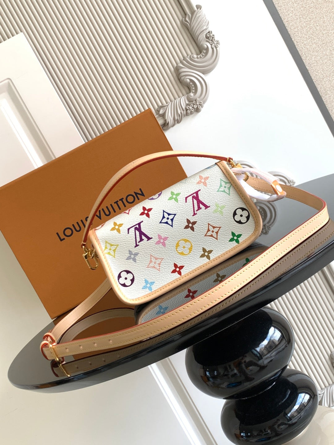 Multicolor monogram crossbody bag with top flap and tan strap, gold hardware.