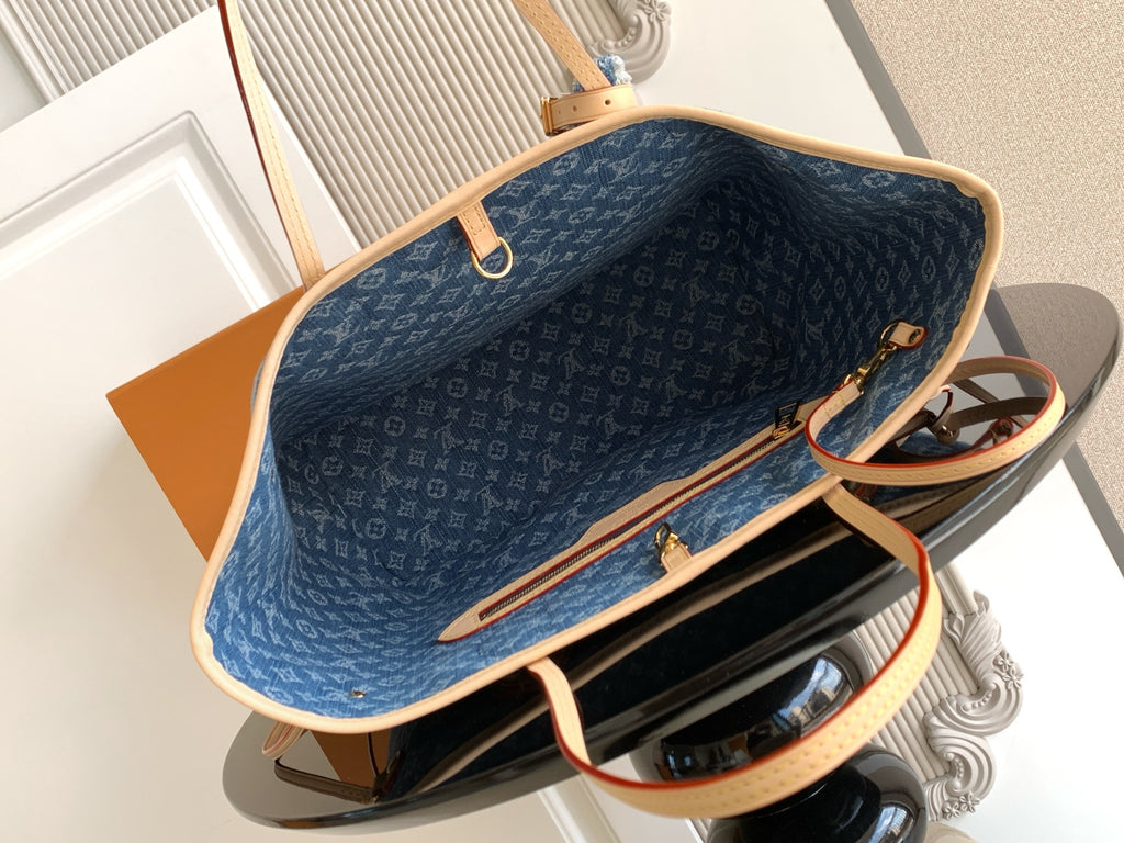 Blue monogram tote bag interior with tan trim and open top closure