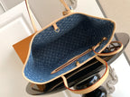 Blue monogram tote bag interior with tan trim and open top closure