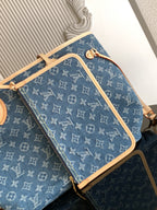 Blue monogram tote bag with tan crossbody strap and zippered front pocket