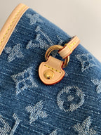 Blue monogram tote bag close-up: tan lock and gold-tone keyhole charm