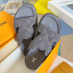 Grey Louis Vuitton slide sandals top view showing embossed monogram strap and logo