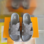Grey Louis Vuitton slide sandals pair facing forward with patterned crossover straps