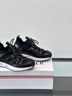 Two black Moncler sneakers side-by-side, lace-up design with sporty strap overlays.
