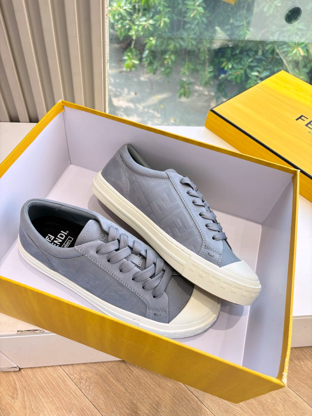 Fendi ladies sneakers in gray, pair on box with lace-up front and white sole