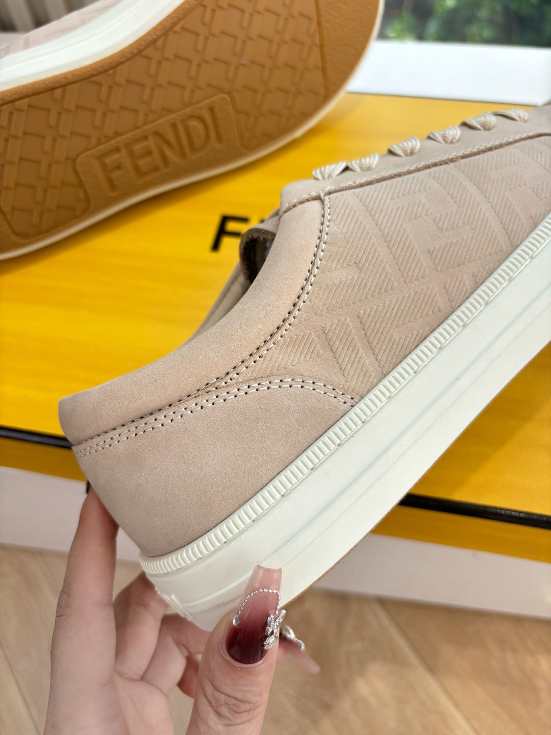 Beige lace-up sneaker heel and sole, with tread and FENDI embossing.