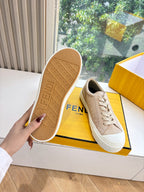Beige sneaker outsole with FENDI text and tread pattern, viewed from bottom.