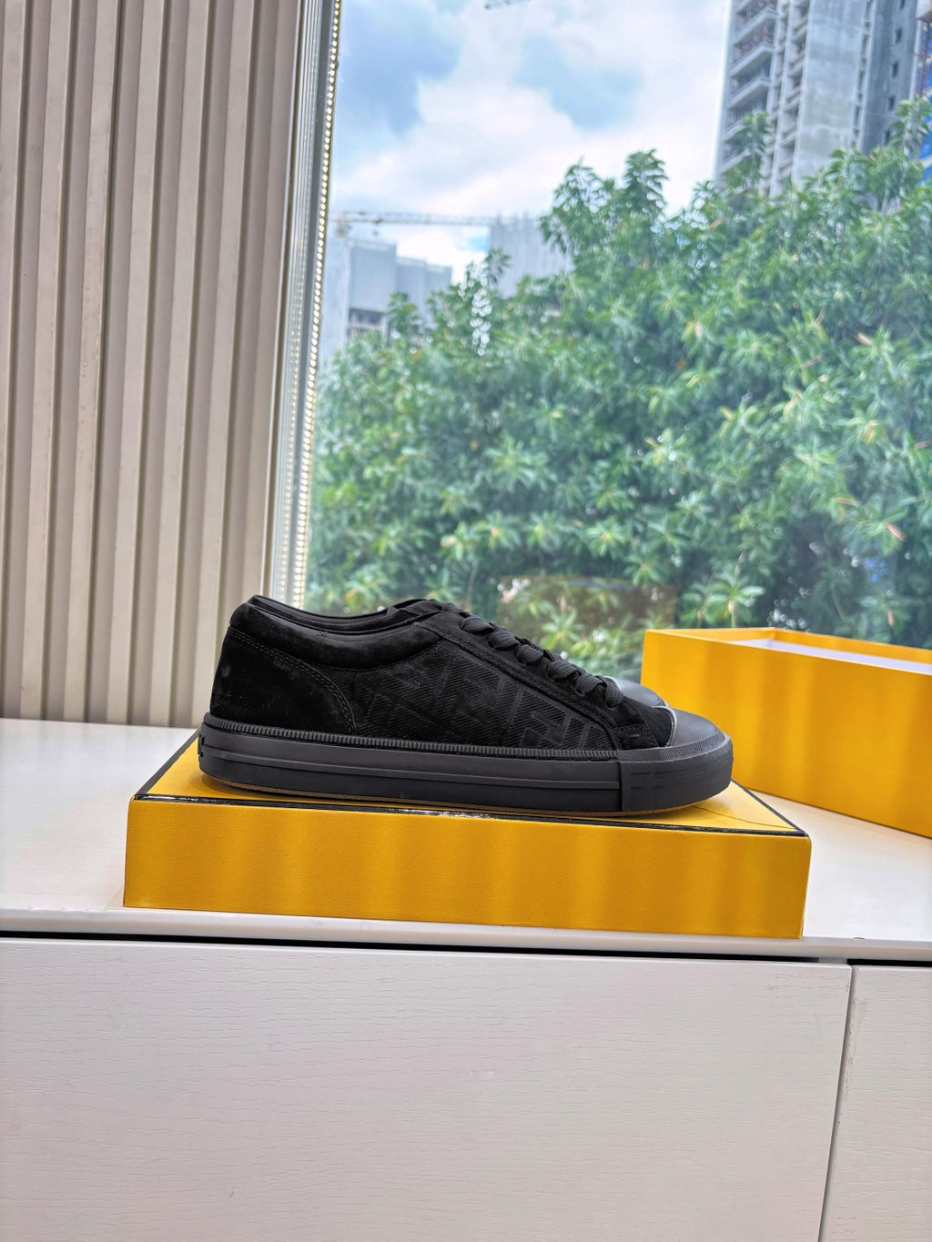 Black Fendi low-top sneaker on a box, lace-up front and rubber sole