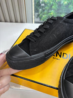 Black Fendi sneaker close-up with lace-up top and embossed side pattern