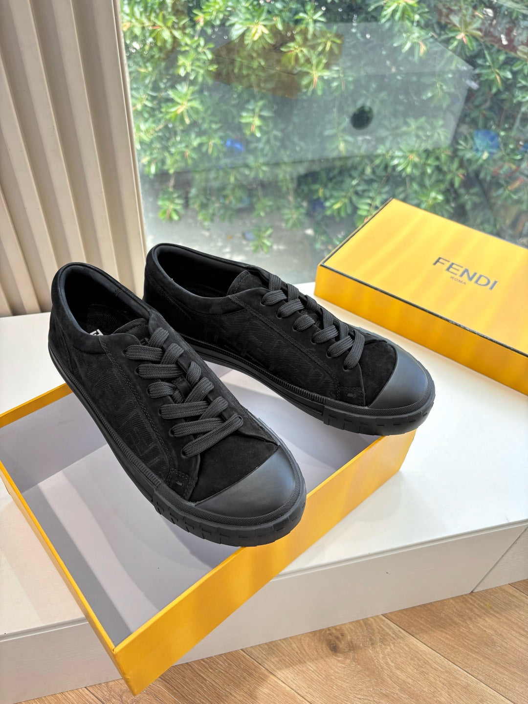 Black lace-up Fendi sneakers with textured logo panels and rubber sole