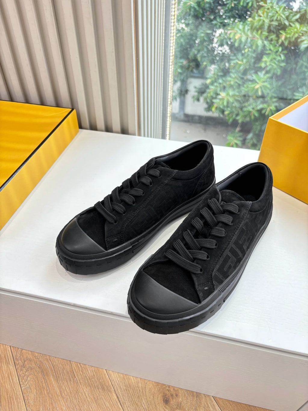 Black lace-up Fendi sneakers with embossed side detail and rubber sole